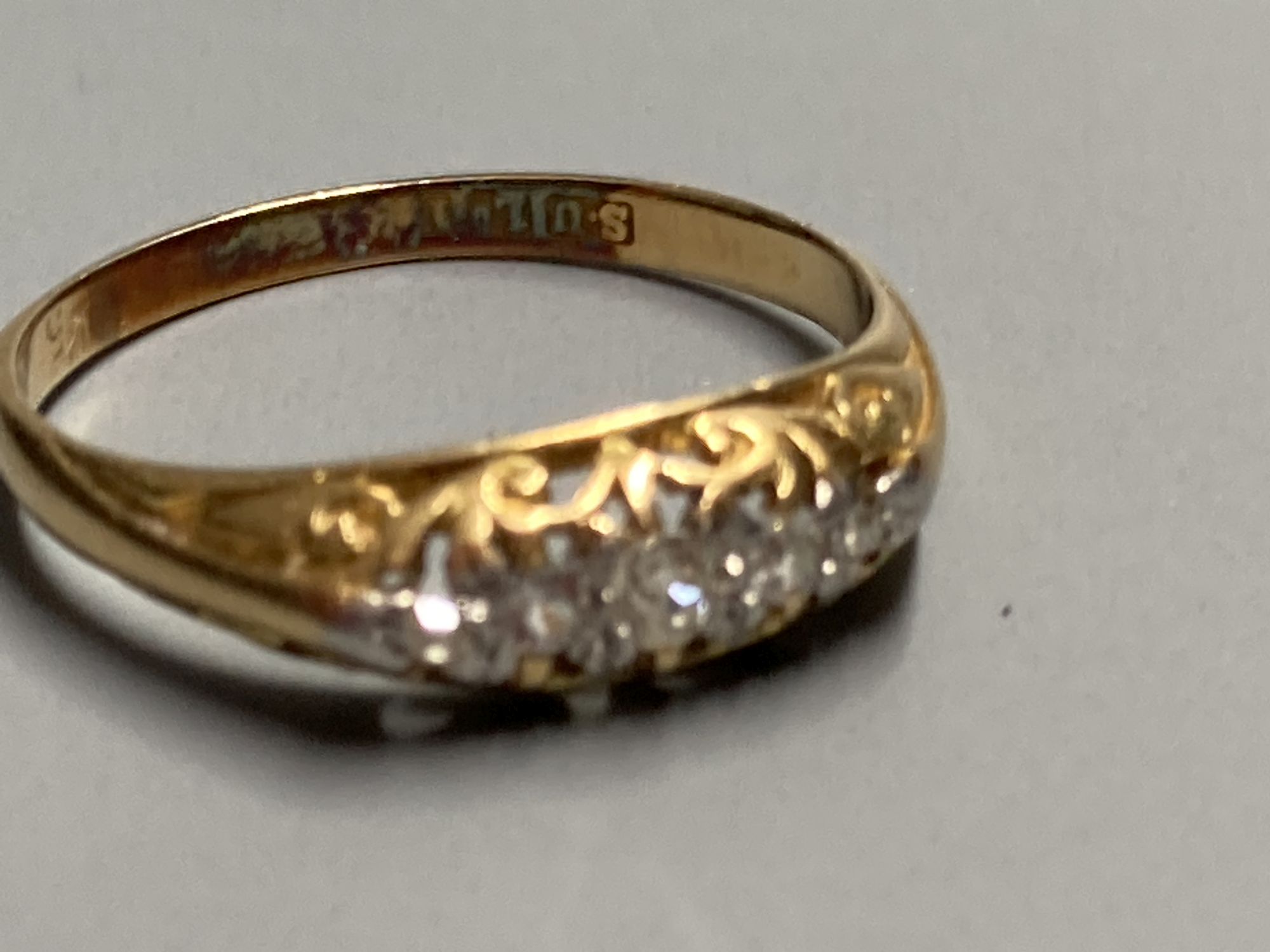 An early 20th century 18ct gold and graduated five stone diamond ring, size O, gross 2.1 grams.